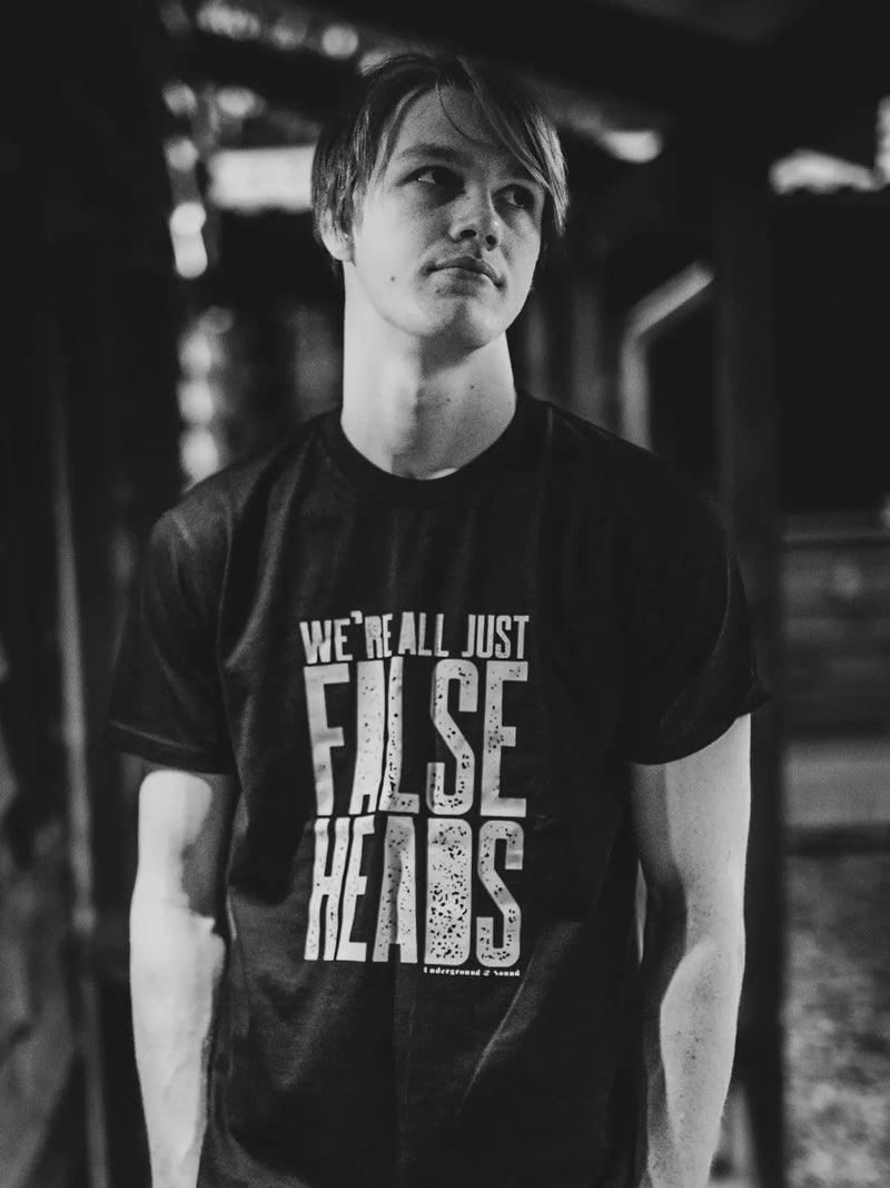 Black and white picture of Charlie Gregory, the drummer for the band False Heads, wearing a band tee