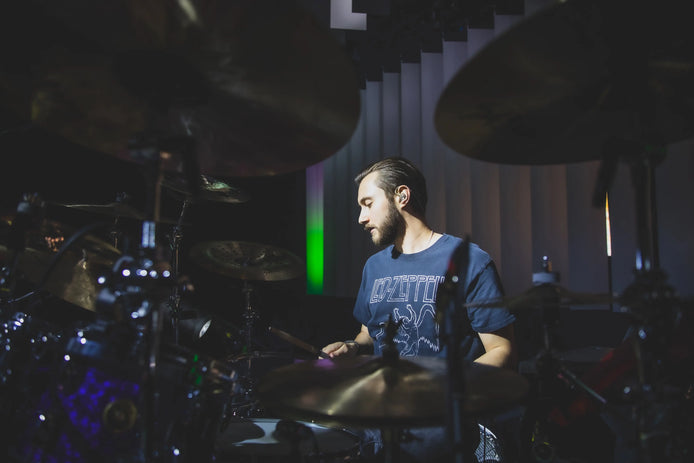 Above Average Clothing endorser Nic Collins drumming, wearing a blue Led Zeppelin tee