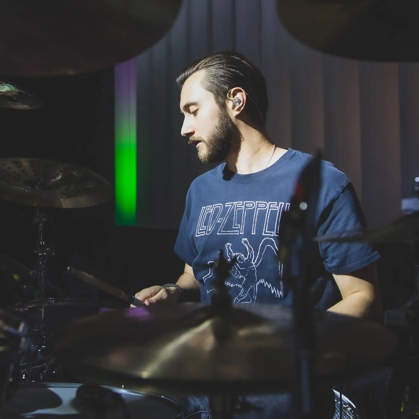 Above Average Clothing endorser Nic Collins drumming, wearing a blue Led Zeppelin tee
