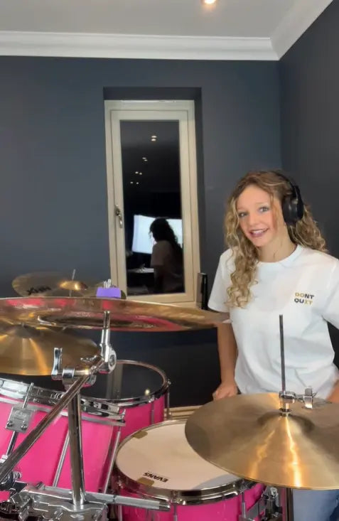 drummer lola teague weraing her white Above Average dont quit tee