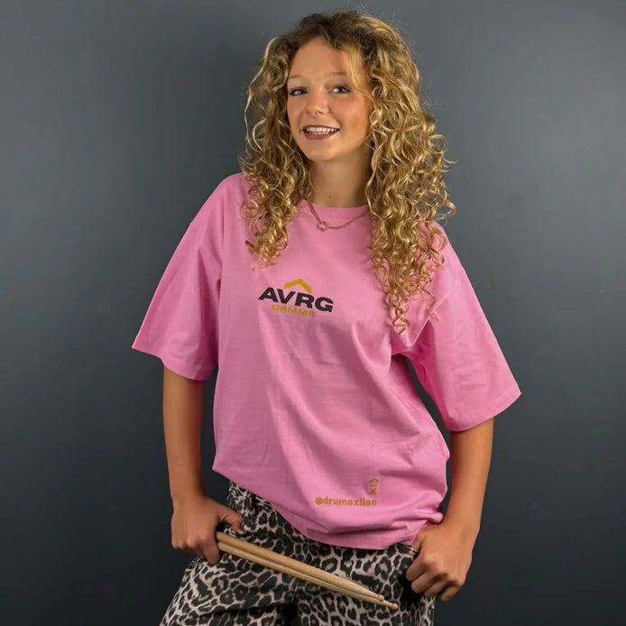 drummer Lola Teague smiling at the camera in her Above Average oversized tee