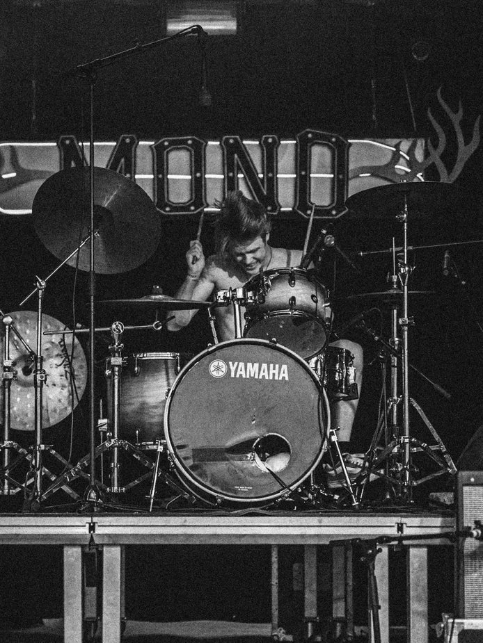 Charlie Gregory drumming on stage