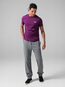 Man wearing purple CORE organic cotton tee with Above Average Clothing wordmark logo, sustainable mindset-led streetwear designed in the UK for everyday wear and modern identity.