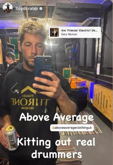 Man taking a selfie in a bar with text overlay about 'Above Average' clothing brand.