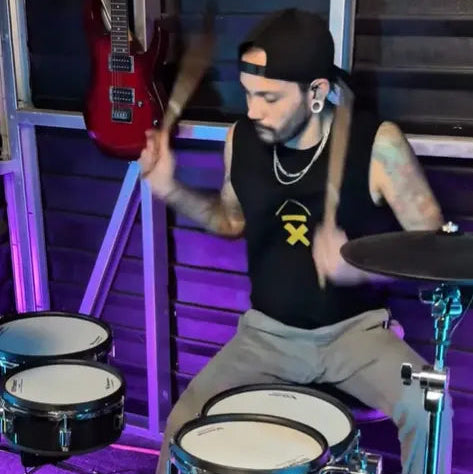 J Boye music drumming wearing his Above Average Clothing tee
