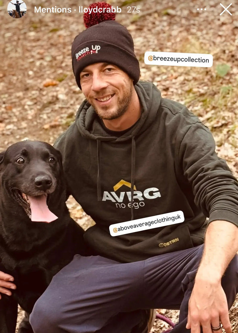 lloyd crabb wearing his above average equestrian hoodie on a dog walk with hid black labrador