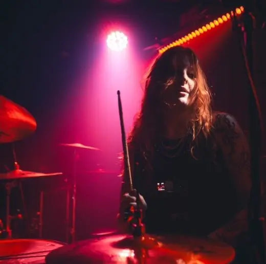 emily irving on stage playing drums